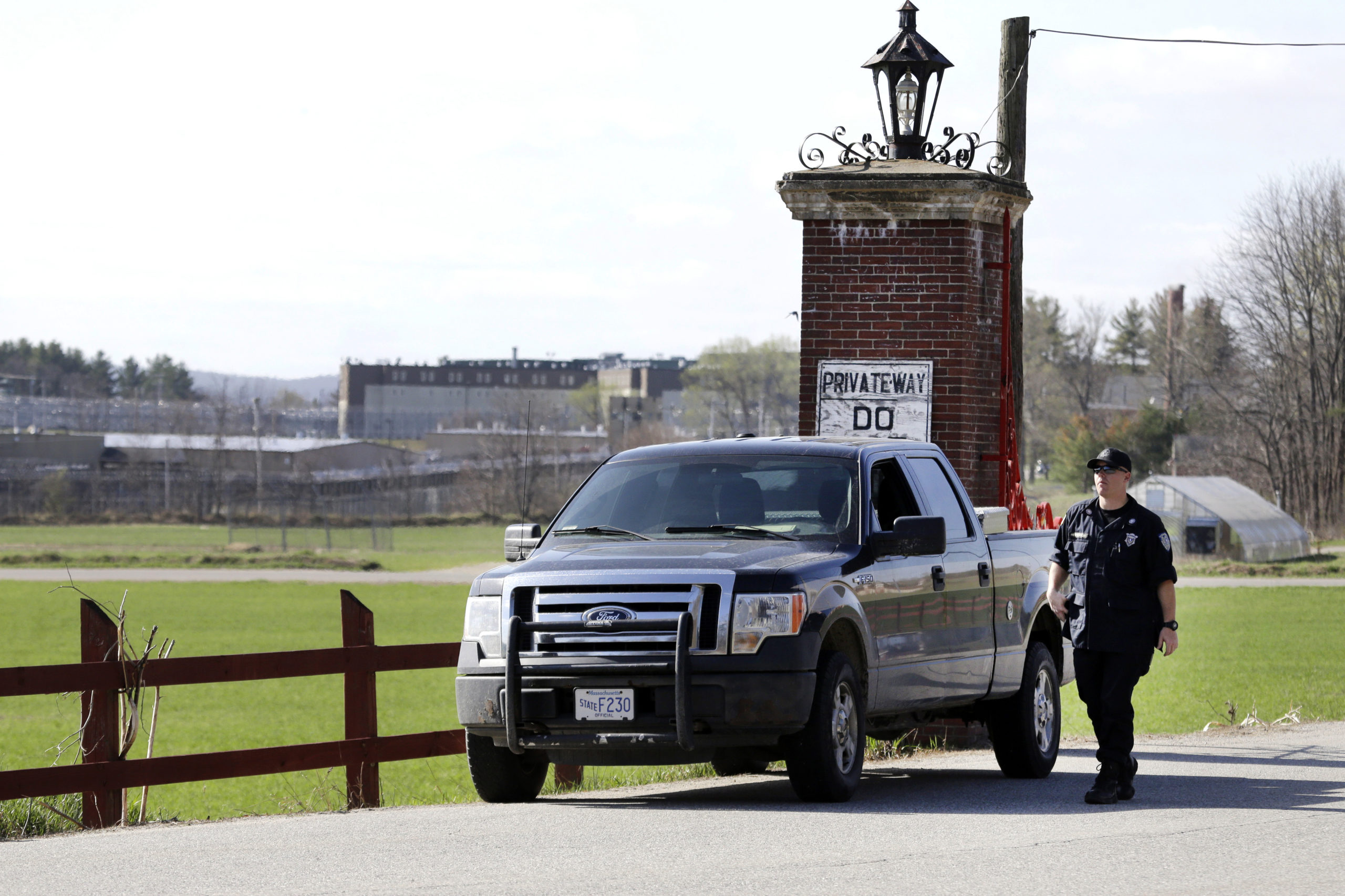 A police officer guards an entrance to the Souza-Baranowski Correctional Center in Shirley, Massachusetts, on Wednesday.