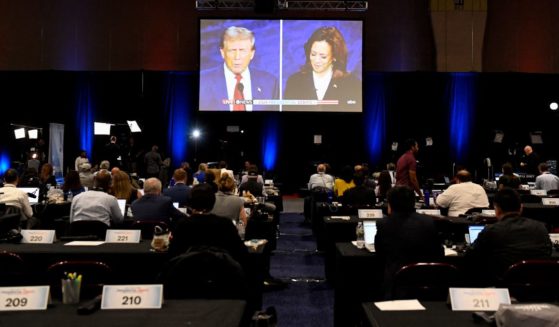 Journalists and members of the media watch former President Donald Trump and Vice President Kamala Harris debate from the spin room in Philadelphia, Pennsylvania, on Tuesday.