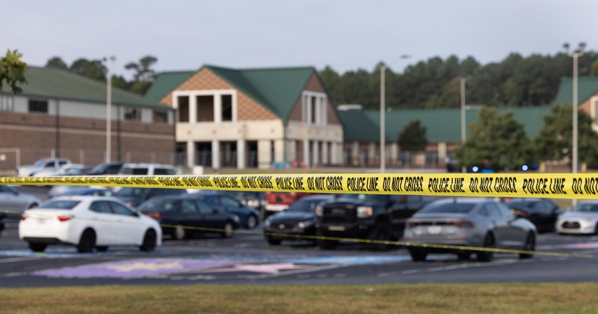 Police tape surrounds the perimeter of Apalachee High School Wednesday in Winder, Georgia, after a gunman killed two students and two teachers and wounded nine others. A 14-year-old suspect, who is a student at the school, is in custody.