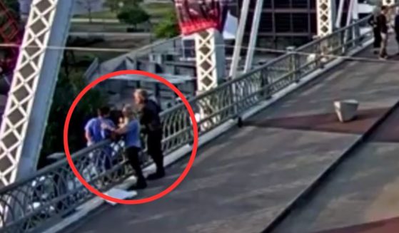 Rock star philanthropist Jon Bon Jovi and a companion talked to the woman out of jumping from the ledge of a pedestrian bridge Tuesday night.