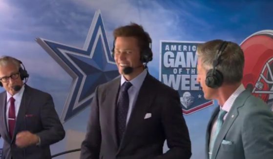 Tom Brady, center, smiles awkwardly after Mike Pereira, left, initially ignored his fist bump at the start of Brady's first NFL broadcast on Sunday.