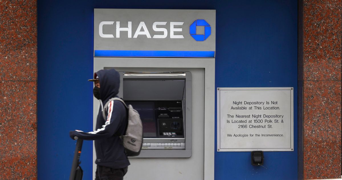 A pedestrian walks by a Chase bank ATM in San Francisco, California, on July 13, 2021.