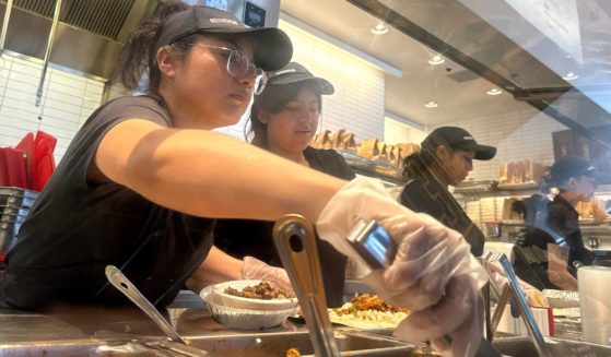 Workers fill food orders at a Chipotle restaurant in San Rafael, California, on April 1.