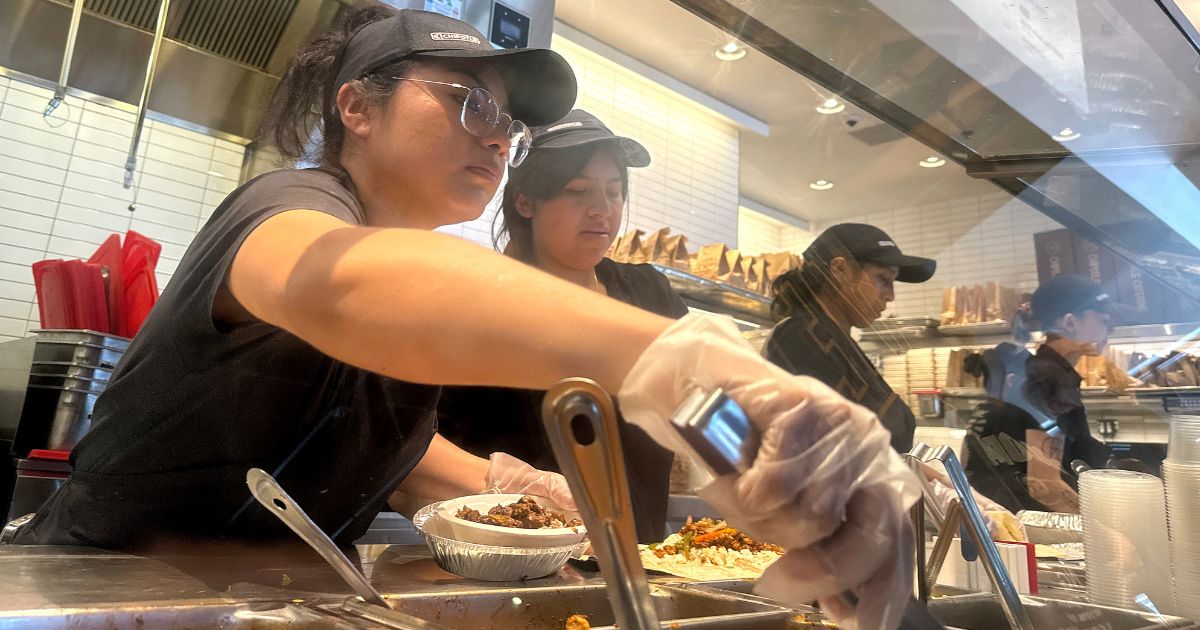 Workers fill food orders at a Chipotle restaurant in San Rafael, California, on April 1.