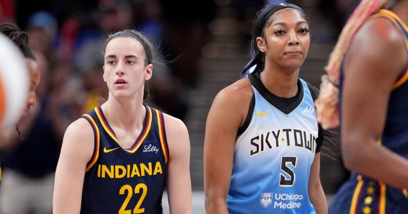 Rookies Caitlin Clark of the Indiana Fever, left, and Angel Reese of the Chicago Sky, right, look on during a game in Indianapolis, Indiana, on June 16.