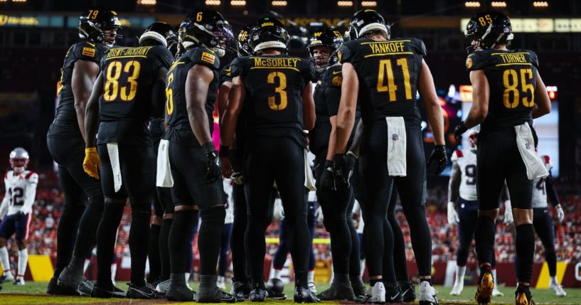 The Washington Commanders' offense huddles up during a game against the New England Patriots in Landover, Maryland, on Aug. 25.