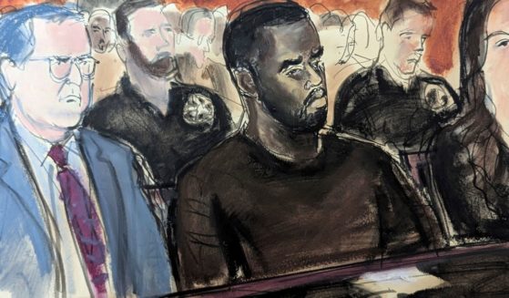 This court drawing shows Sean "Diddy" Combs flanked by his defense attorney Marc Agnifilo, left, and Teny Garagos, right, in Manhattan Federal Court in New York City on Tuesday.