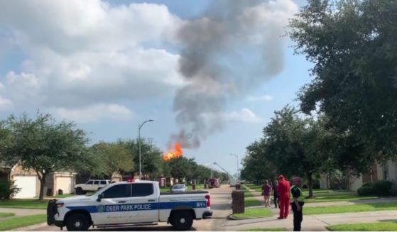 A massive fire burns near Houston, Texas, on Monday after an SUV crashed through a fence and hit a natural gas pipeline, causing some nearby residents to be evacuated.