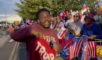 A black Trump supporter confronts Haitian protesters outside the former president's New York rally Wednesday.