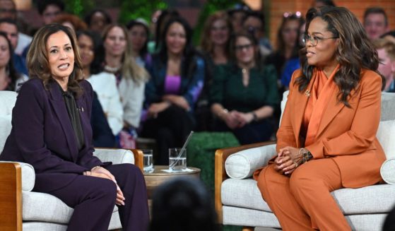 Vice President Kamala Harris, left, speaks with Oprah Winfrey, right, during a town hall in Farmington Hills, Michigan, on Thursday.