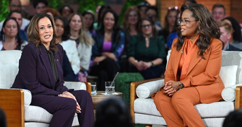 Vice President Kamala Harris, left, speaks with Oprah Winfrey, right, during a town hall in Farmington Hills, Michigan, on Thursday.