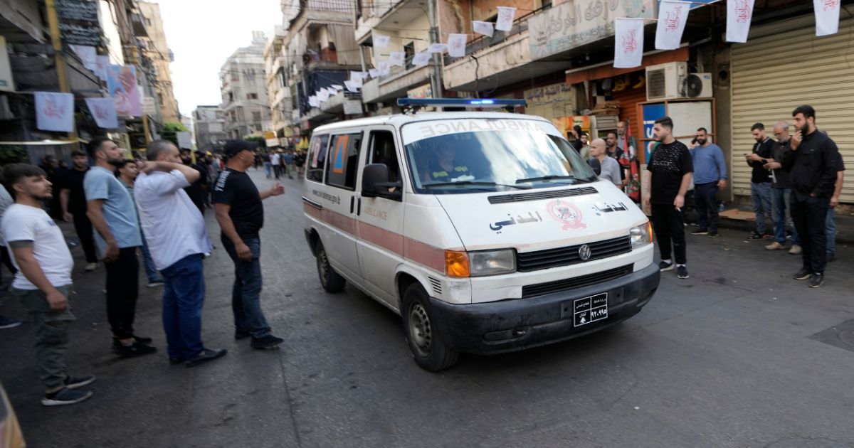 An ambulance, believed to be carrying wounded Hezbollah members, drives through Beirut, Lebanon, on Wednesday, following multiple explosions at a funeral for four Hezbollah fighters who were killed Tuesday.