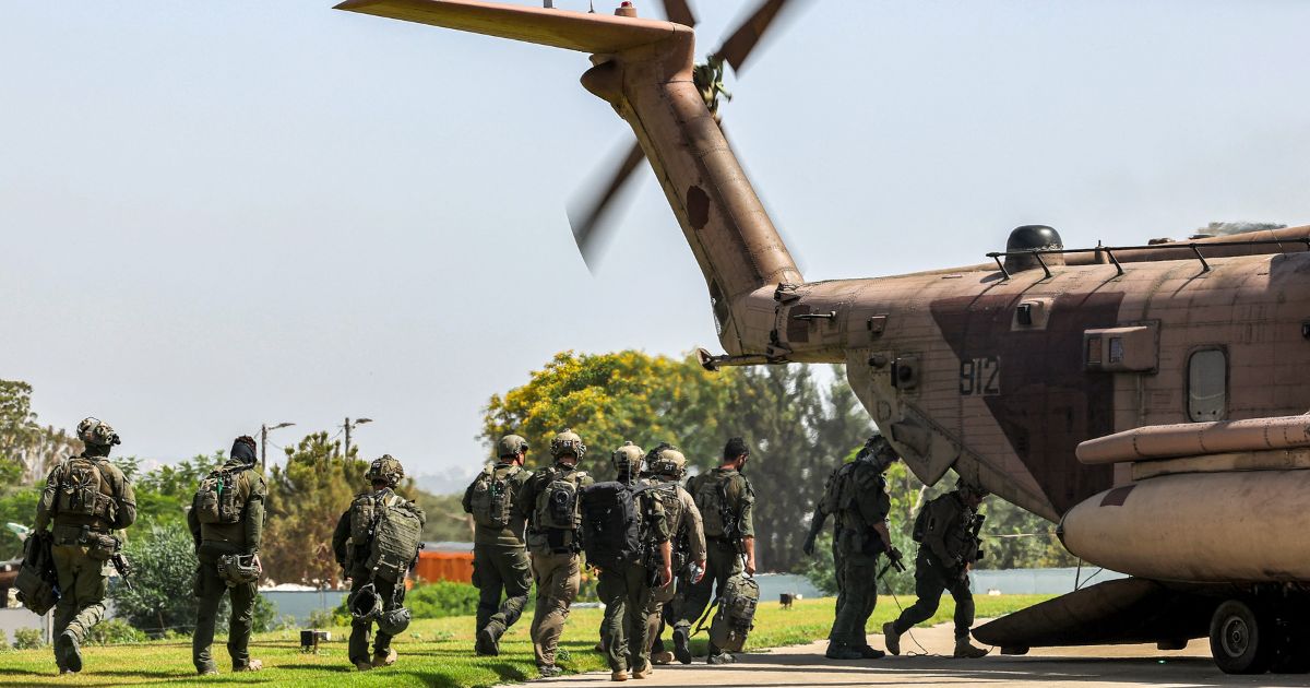 Israeli army special forces soldiers board a CH-53 Sea Stallion military helicopter before departing from the helipad of Sheba Tel-HaShomer Medical Centre in Ramat Gan on June 8.