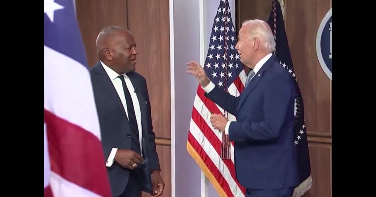 Watch: Smirking Biden Ignores Reporters Until Handler Escorts Him from Room