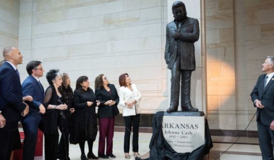 A statue of country music singer and Arkansas native Johnny Cash is unveiled Tuesday as House Minority Leader Hakeem Jeffries (second from left), Democrat of New York, and Speaker of the House Mike Johnson (third from left), alongside members of the Cash family, watch in Emancipation Hall on Capitol Hill in Washington, D.C..