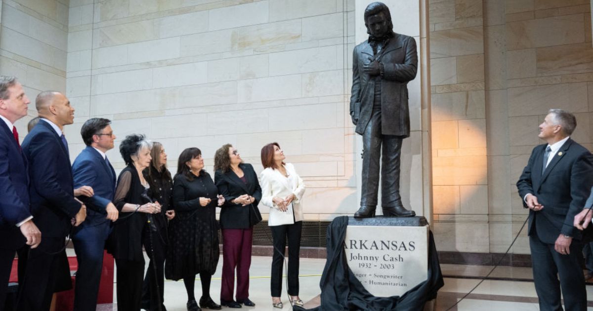 A statue of country music singer and Arkansas native Johnny Cash is unveiled Tuesday as House Minority Leader Hakeem Jeffries (second from left), Democrat of New York, and Speaker of the House Mike Johnson (third from left), alongside members of the Cash family, watch in Emancipation Hall on Capitol Hill in Washington, D.C..