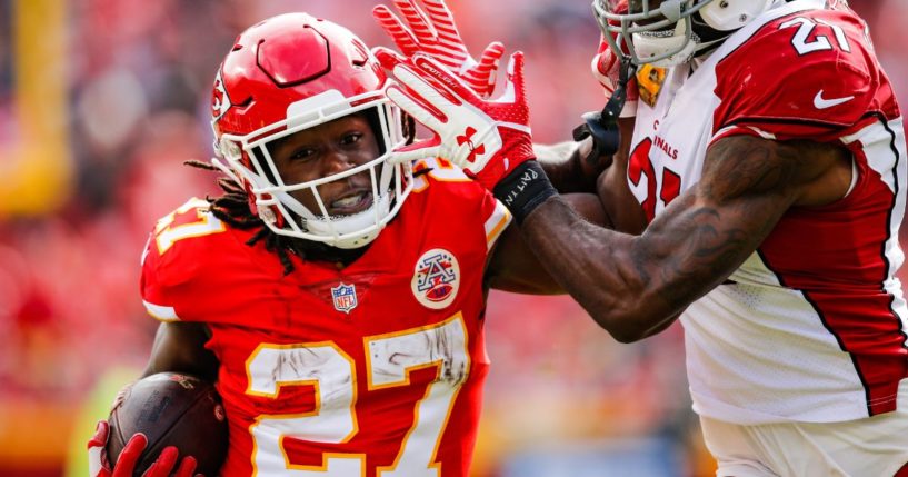 Kareem Hunt of the Kansas City Chiefs, left, tries to fight off a tackle from Patrick Peterson of the Arizona Cardinals, right, during the first half of the game at Arrowhead Stadium in Kansas City, Missouri, Nov. 11, 2018.