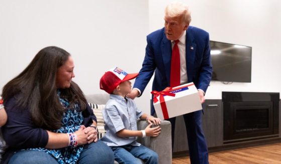 Former President Donald Trump, right, met his 8-year-old fan, Liam Licastro and his family, including Liam's mother Siobhan, left, before a campaign rally Wednesday in New York.