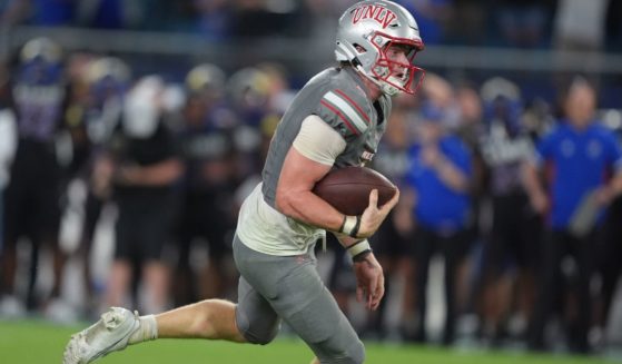 Quarterback Matthew Sluka of the UNLV Rebels drives upfield during the fourth quarter against the Kansas Jayhawks in Kansas City, Kansas, on Sept. 13.