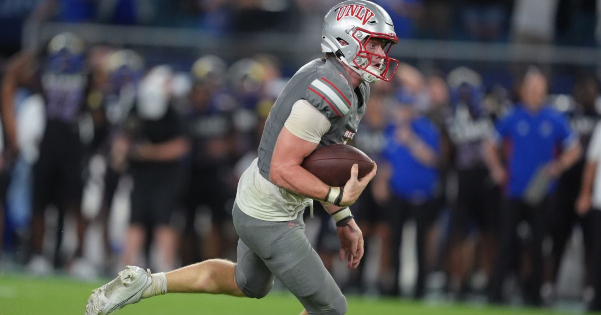 Quarterback Matthew Sluka of the UNLV Rebels drives upfield during the fourth quarter against the Kansas Jayhawks in Kansas City, Kansas, on Sept. 13.