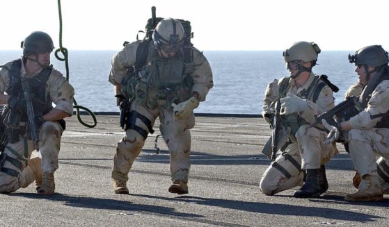 U.S. Navy SEALs complete rappelling from a helicopter to the deck of the amphibious command ship USS Mount Whitney during a training exercise on Jan. 17, 2023.