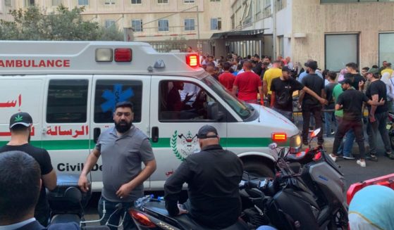 People gather outside the American University hospital after the arrival of several men who were wounded by exploded handheld pagers, in Beirut, Lebanon, on Tuesday.