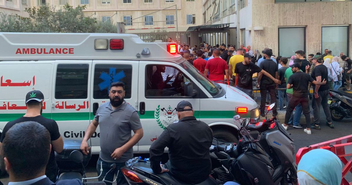 People gather outside the American University hospital after the arrival of several men who were wounded by exploded handheld pagers, in Beirut, Lebanon, on Tuesday.