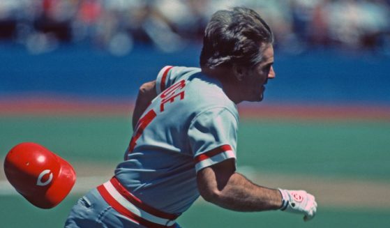 Pete Rose of the Cincinnati Reds loses his helmet as he runs to first base against the Pittsburgh Pirates during a Major League Baseball game in Pittsburgh, Pennsylvania, in 1985.