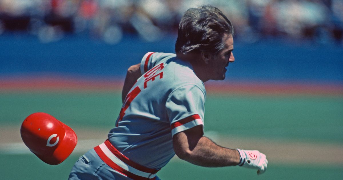 Pete Rose of the Cincinnati Reds loses his helmet as he runs to first base against the Pittsburgh Pirates during a Major League Baseball game in Pittsburgh, Pennsylvania, in 1985.