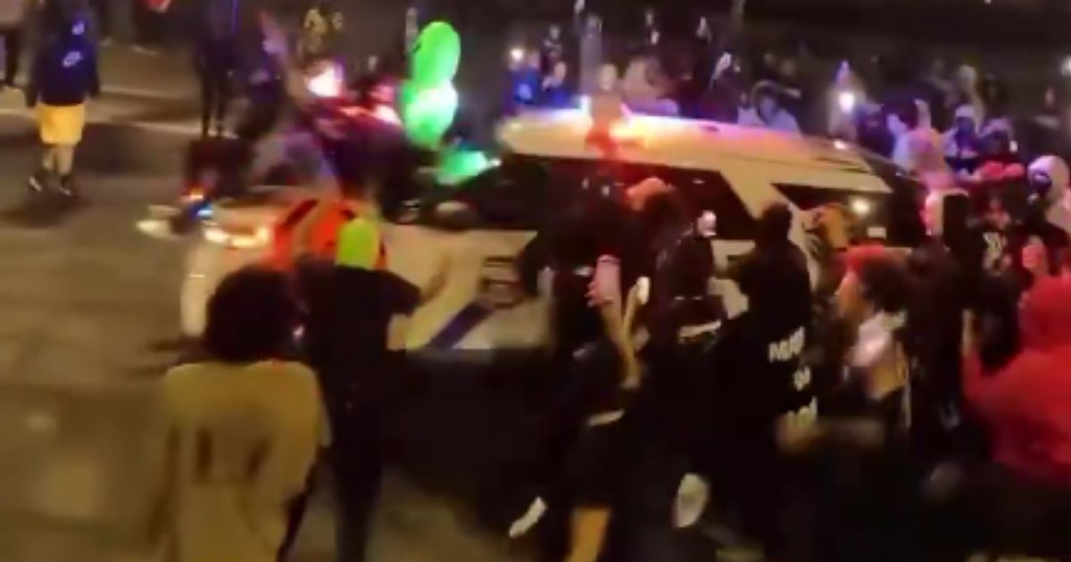 Drone footage from the weekend shows a mob of people circling a police vehicle in Philadelphia, Pennsylvania.