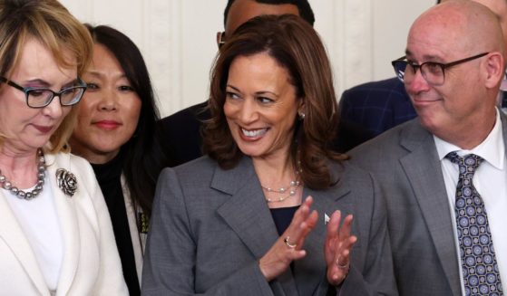 U.S. President Joe Biden hands a pen to Rep. Lucy McBath, who lost her son, Jordan Russell Davis, to gun violence in 2012, after signing an executive order that included gun-related legislation, including the creation of a task force to assess the threat of machine gun conversion devices, during an event in the East Room of the White House September 26, 2024 in Washington, DC.