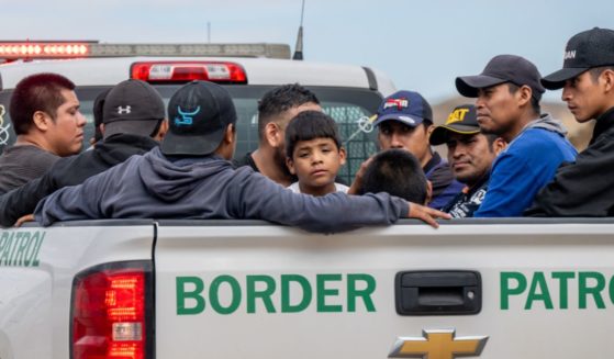 Migrants seeking asylum from Central and South America sit in the back of a border patrol vehicle after being apprehended by U.S. Customs and Border protection officers after illegally crossing over into the U.S. on June 24, 2024 in Ruby, Arizona.