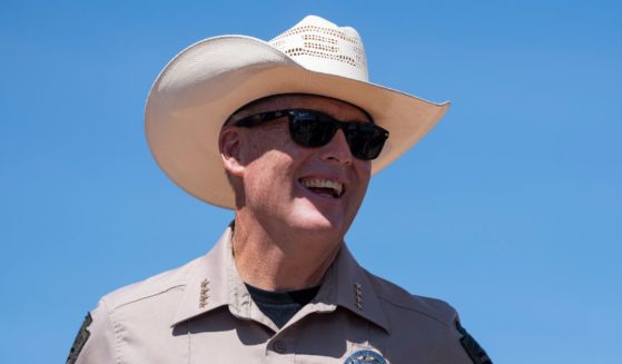 Cochise County Sheriff Mark Dannels laughs while at the U.S.-Mexico border on August 22, 2024 south of Sierra Vista, Arizona.