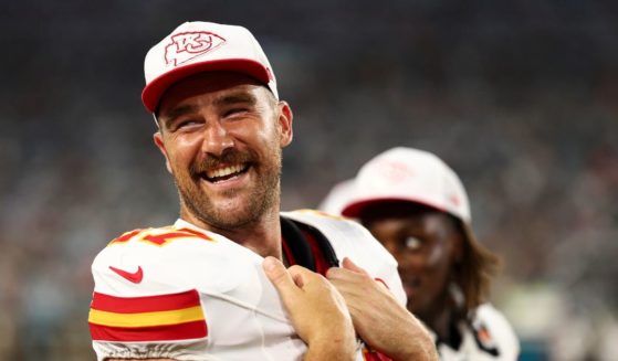 Travis Kelce #87 of the Kansas City Chiefs smiles on the sidelines during the second quarter of an NFL preseason football game against the Jacksonville Jaguars.