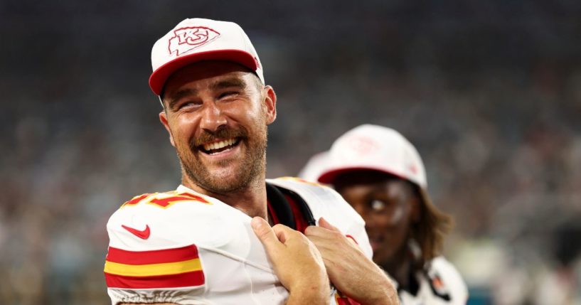 Travis Kelce #87 of the Kansas City Chiefs smiles on the sidelines during the second quarter of an NFL preseason football game against the Jacksonville Jaguars.