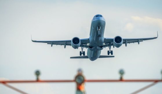 A passenger jet takes off over the runway threshold lights at Ronald Reagan Washington National Airport on August 12, 2024, in Arlington, Virginia.