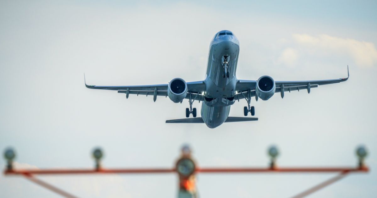 A passenger jet takes off over the runway threshold lights at Ronald Reagan Washington National Airport on August 12, 2024, in Arlington, Virginia.