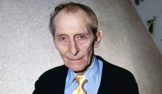 Portrait of British actor Peter Cushing (1913 - 1994) as he poses with a copy of his book, 'Peter Cushing: An Autobiography,' London, England, February 13, 1986.