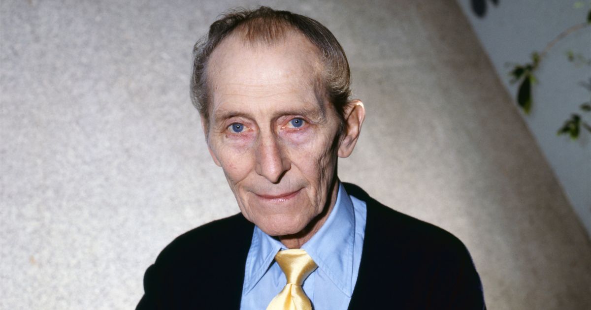 Portrait of British actor Peter Cushing (1913 - 1994) as he poses with a copy of his book, 'Peter Cushing: An Autobiography,' London, England, February 13, 1986.