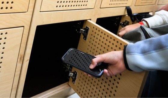 tudents put their mobile phones in their lockers after switching them off, as it is mandatory in the Auguste Brizeux highschool in Lorient, western France, on September 5, 2024.