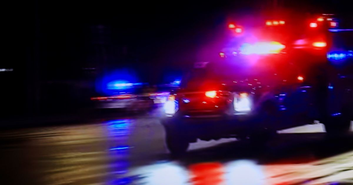 Stock image of an emergency vehicle with lights activated.