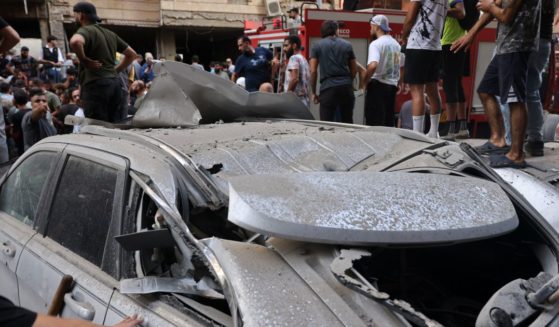 People check the damage following an Israeli strike in Beirut's southern suburbs on September 20, 2024. The Israeli military announced that the commander of Hezbollah's elite Radwan unit, Ibrahim Aqil, and other senior figures of the Lebanese armed group had been killed in the air strike.