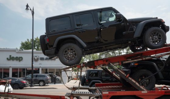 Jeep vehicles are delivered to a dealership on June 20, 2024 in Chicago, Illinois. A cyber attack on CDK Global, a software provider that helps dealerships manage sales and service, has crippled the workflow at approximately 15,000 dealerships across the United States and Canada.