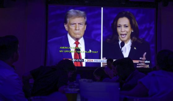 People watch the presidential debate during a debate watch party at Penn Social in Washington, D.C., on Tuesday.