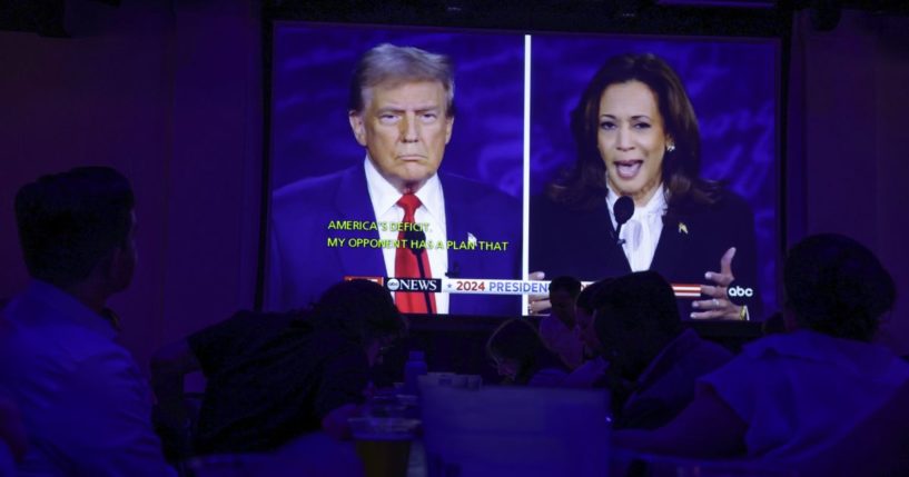 People watch the presidential debate during a debate watch party at Penn Social in Washington, D.C., on Tuesday.