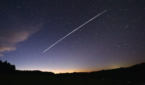 A long-exposure image shows a trail of a group of SpaceX's Starlink satellites passing over Uruguay on Feb. 7, 2021.