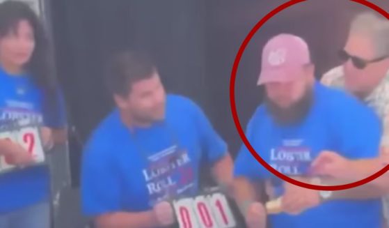 New Hampshire Gov. Chris Sununu, right, performed the Heimlich maneuver on Christian Moreno, second from right, after he began choking during a lobster roll eating contest in Hampton Beach.