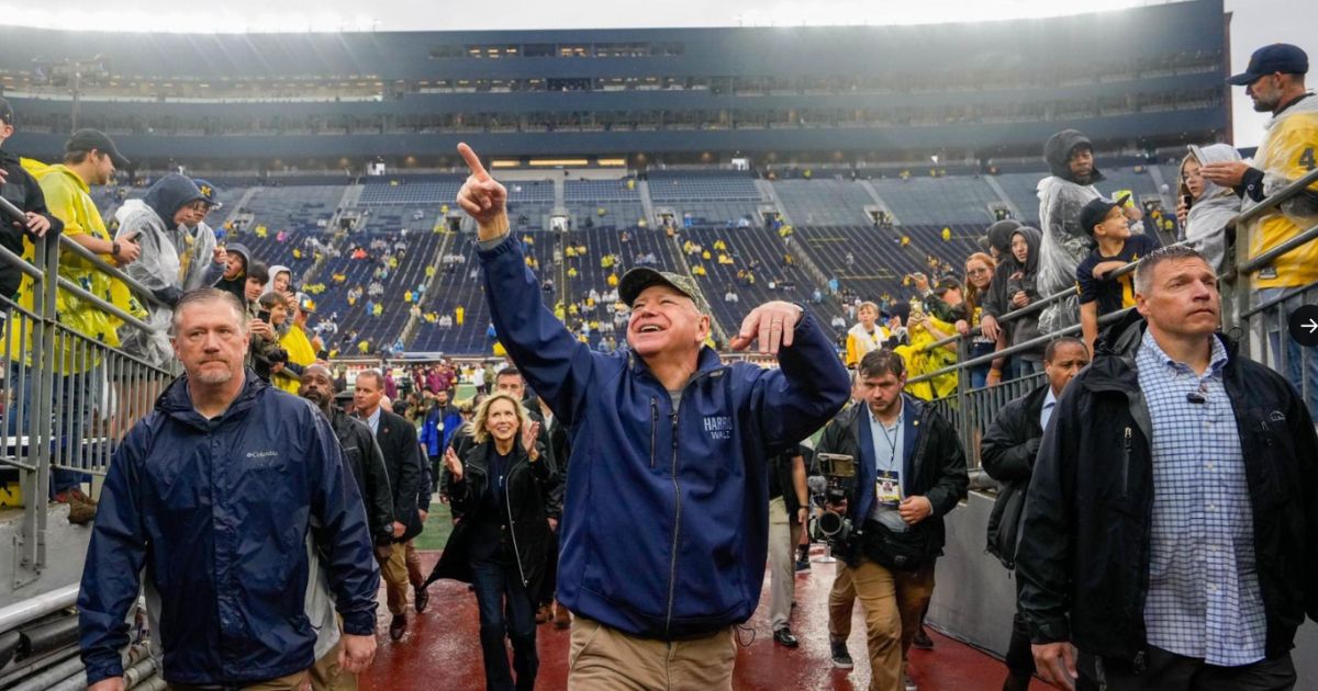 Democratic vice presidential candidate and Minnesota Gov. Tim Walz arrives before the game between the University of Minnesota and University of Michigan in Ann Arbor, Michigan, on Saturday.