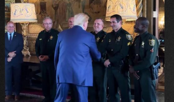 Former President Donald Trump greets the Martin County Sheriff's Office officers who helped apprehend his assailant Sunday.