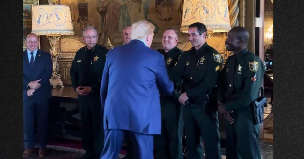 Former President Donald Trump greets the Martin County Sheriff's Office officers who helped apprehend his assailant Sunday.